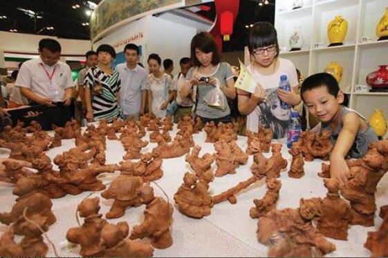 史月明的泥塑《百子戏春》引得众多游人驻足(资料图片)